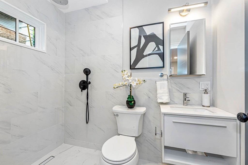 36-38 Johnswood Road Boston, MA 02131 - Photo 16 of 42 a bathroom with a toilet sink and mirror