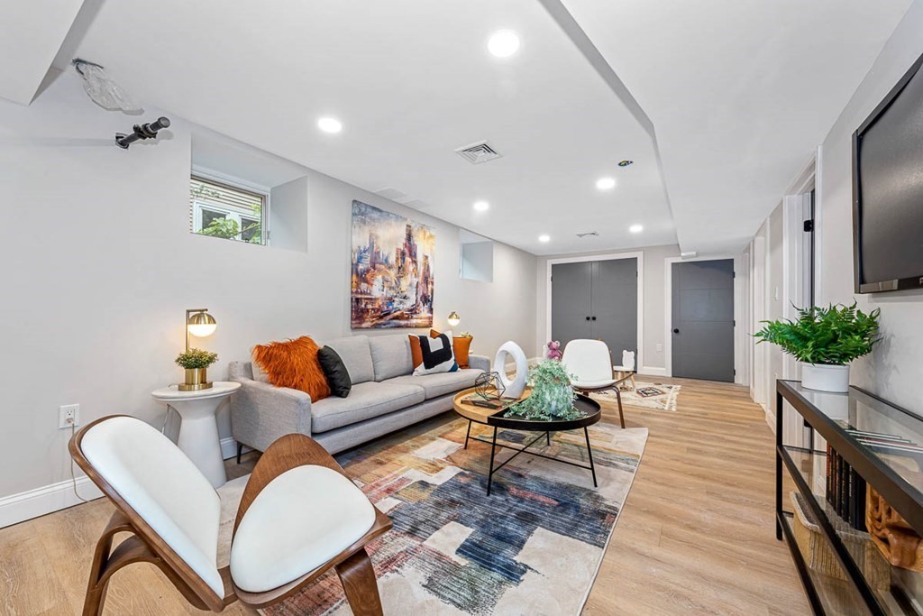 36-38 Johnswood Road Boston, MA 02131 - Photo 18 of 42 a living room with furniture a chandelier and a rug