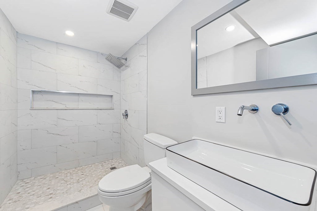 36-38 Johnswood Road Boston, MA 02131 - Photo 21 of 42 a white toilet sitting next to a bathroom sink