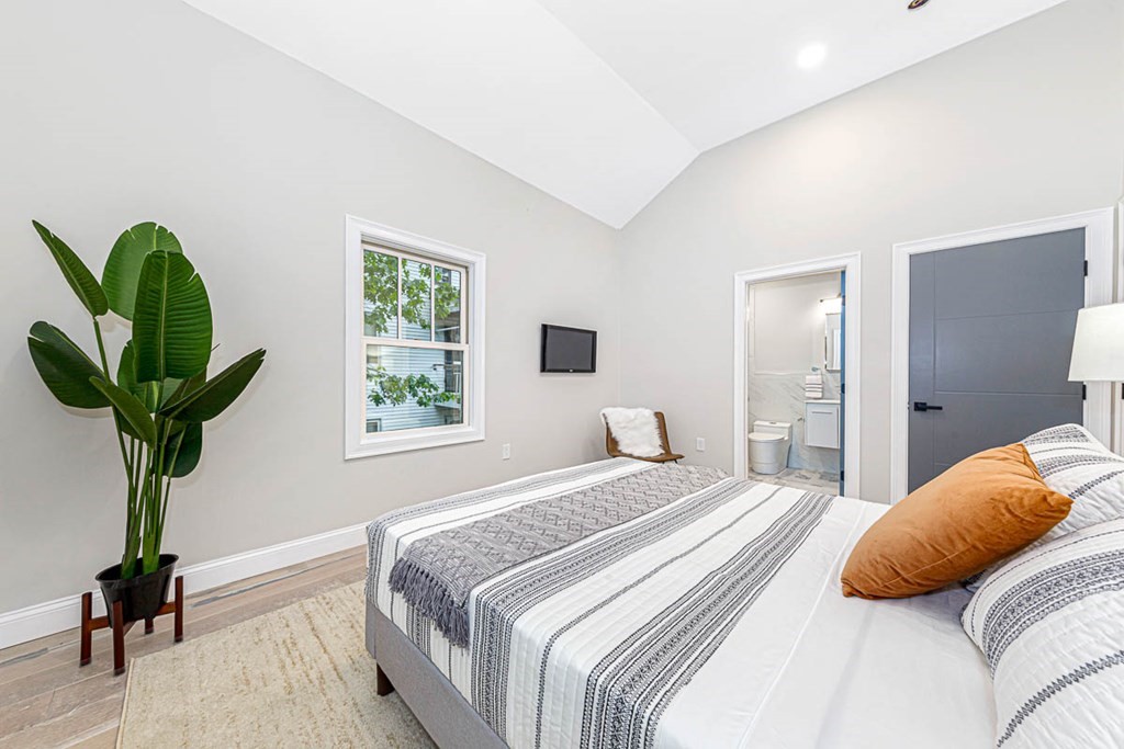 36-38 Johnswood Road Boston, MA 02131 - Photo 41 of 42 a bedroom with a bed and a potted plant