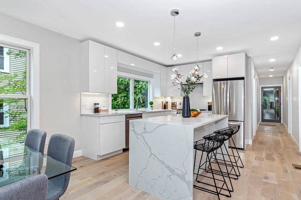 36-38 Johnswood Road Boston, MA 02131 - Photo 9 of 42 a kitchen with a table chairs refrigerator and couch