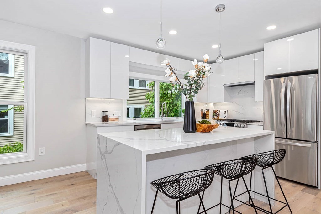 36-38 Johnswood Road Boston, MA 02131 - Photo 10 of 42 a kitchen with a table chairs refrigerator and microwave