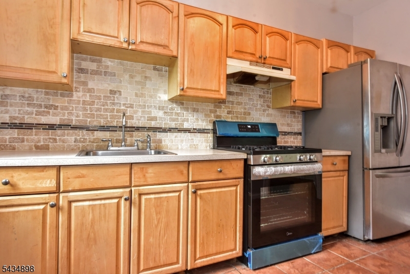 303 Hamilton Place, Unit A4 Hackensack, NJ 07601 - Photo 10 of 13 a kitchen with stainless steel appliances granite countertop a refrigerator a stove and a sink
