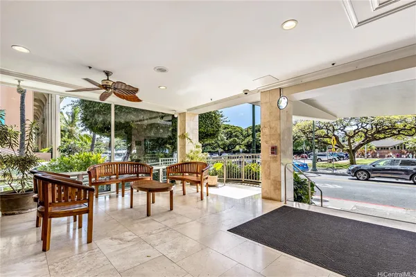 a dining room with furniture and a floor to ceiling window