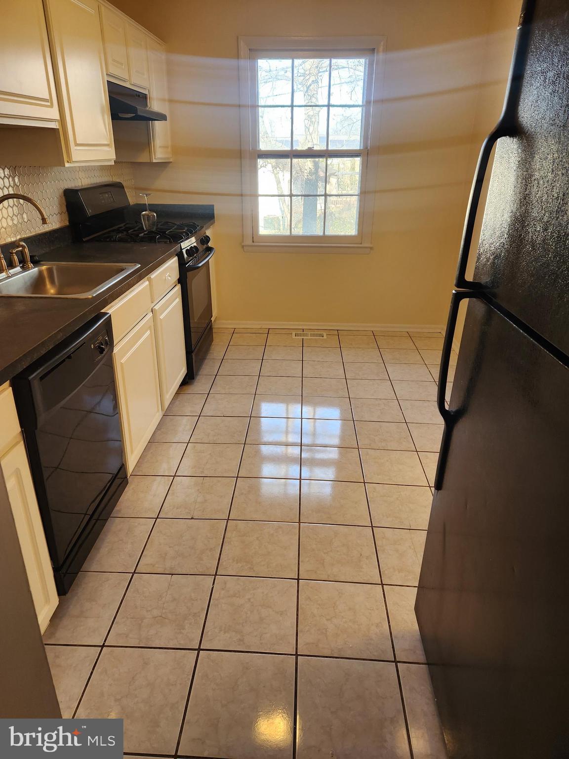 8509 Imperial Drive, Unit 7B Laurel, MD 20708 - Photo 12 of 36 a kitchen with a sink a stove a microwave and a counter top space
