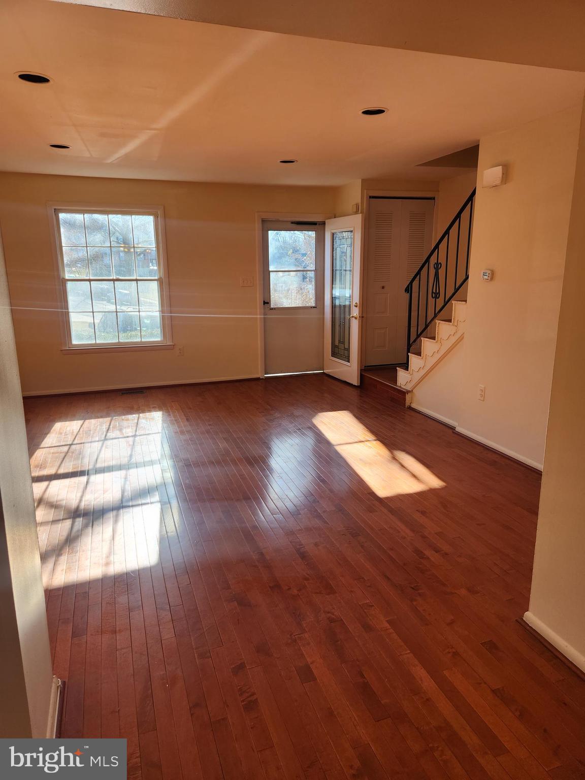 8509 Imperial Drive, Unit 7B Laurel, MD 20708 - Photo 15 of 36 a view of an empty room with wooden floor and a window