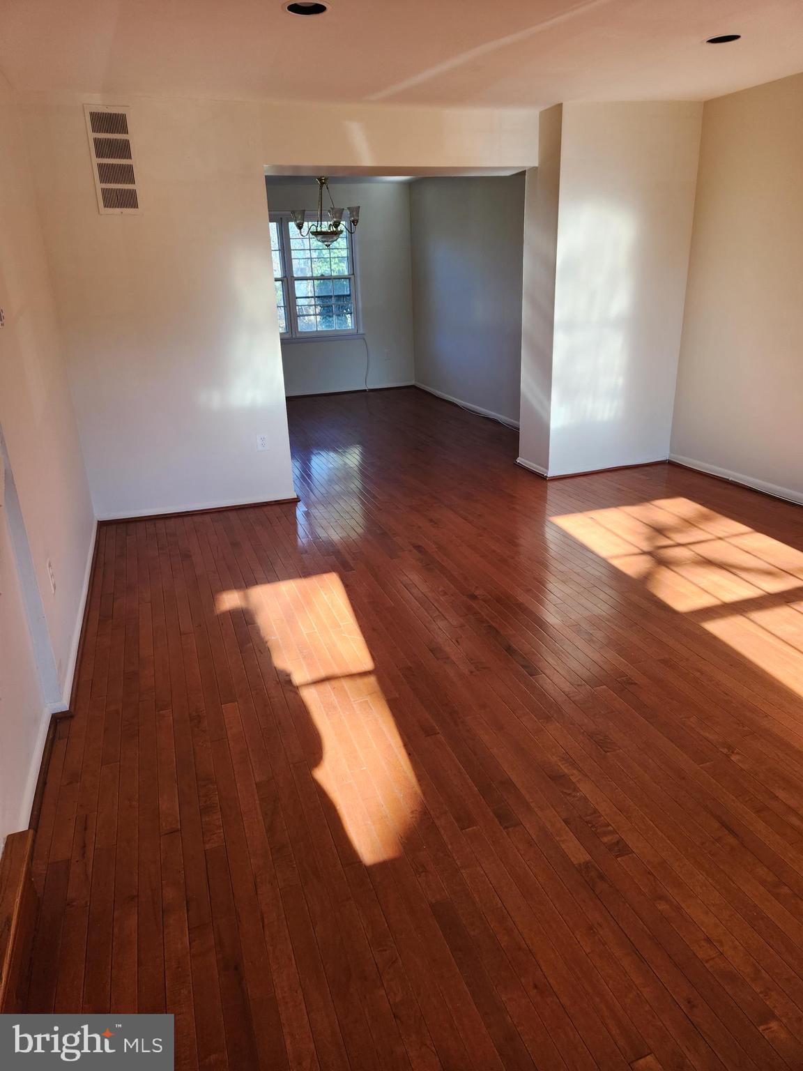 8509 Imperial Drive, Unit 7B Laurel, MD 20708 - Photo 4 of 36 wooden floor in an empty room with a window