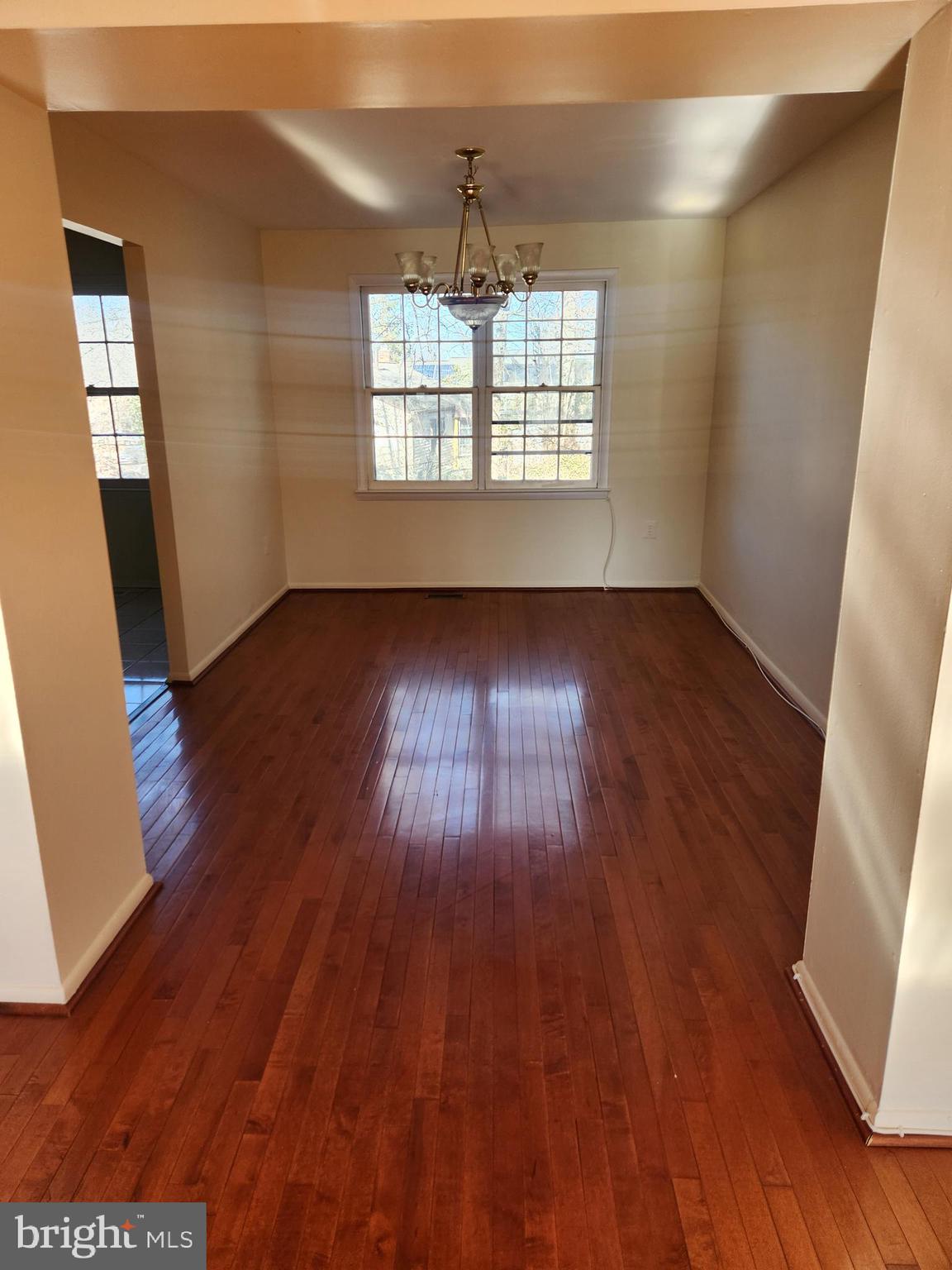8509 Imperial Drive, Unit 7B Laurel, MD 20708 - Photo 5 of 36 an empty room with wooden floor and windows