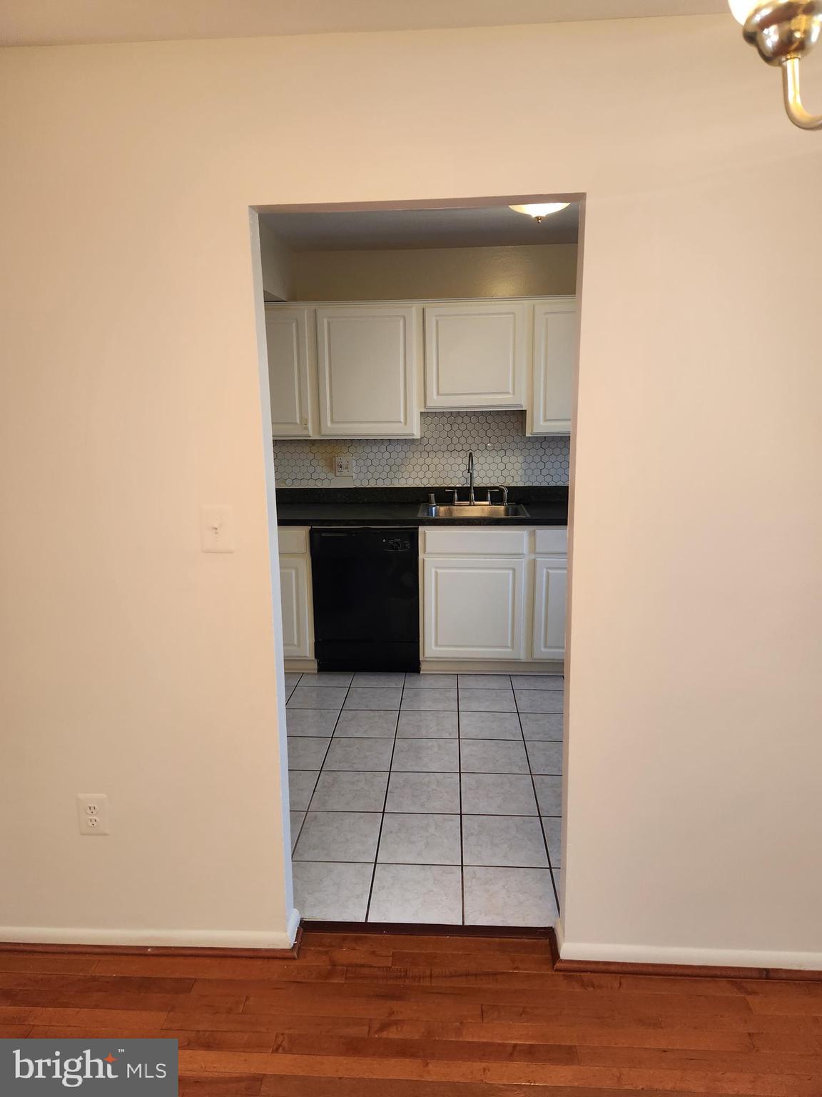 8509 Imperial Drive, Unit 7B Laurel, MD 20708 - Photo 9 of 36 a kitchen with granite countertop a stove a sink and a microwave
