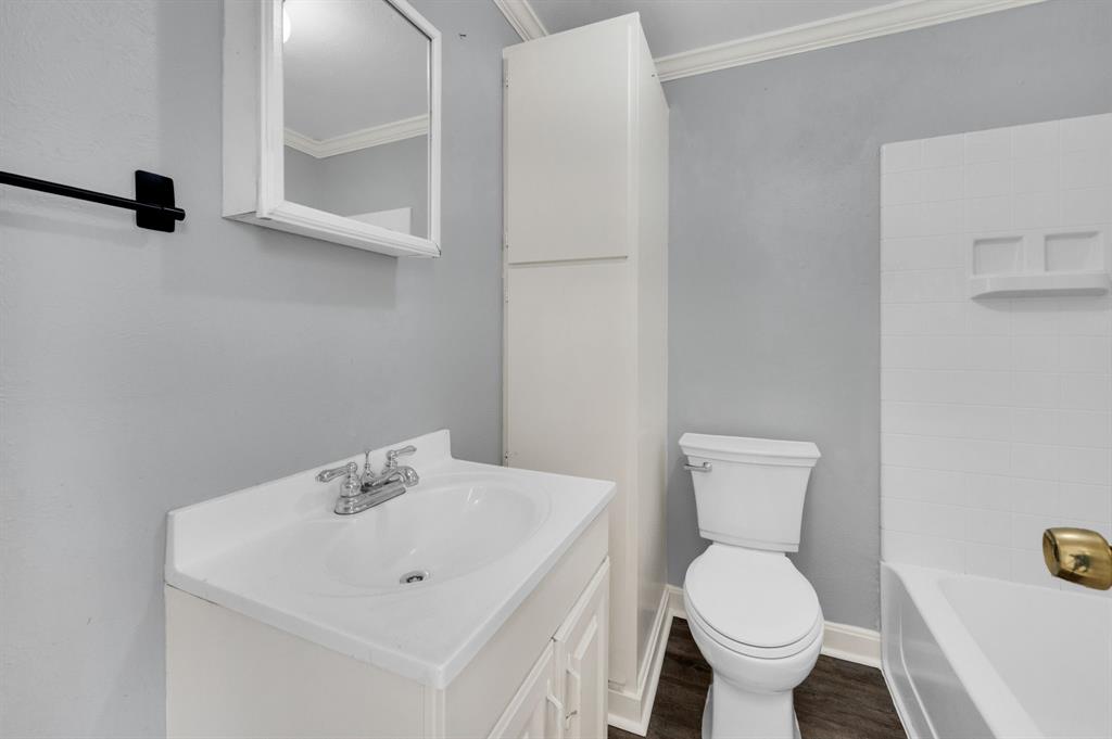 412 East Avenue F Midlothian, TX 76065 - Photo 11 of 12 a bathroom with a sink toilet and a mirror