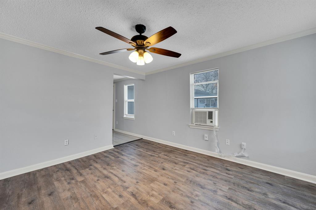 412 East Avenue F Midlothian, TX 76065 - Photo 6 of 12 a view of empty room with wooden floor and fan