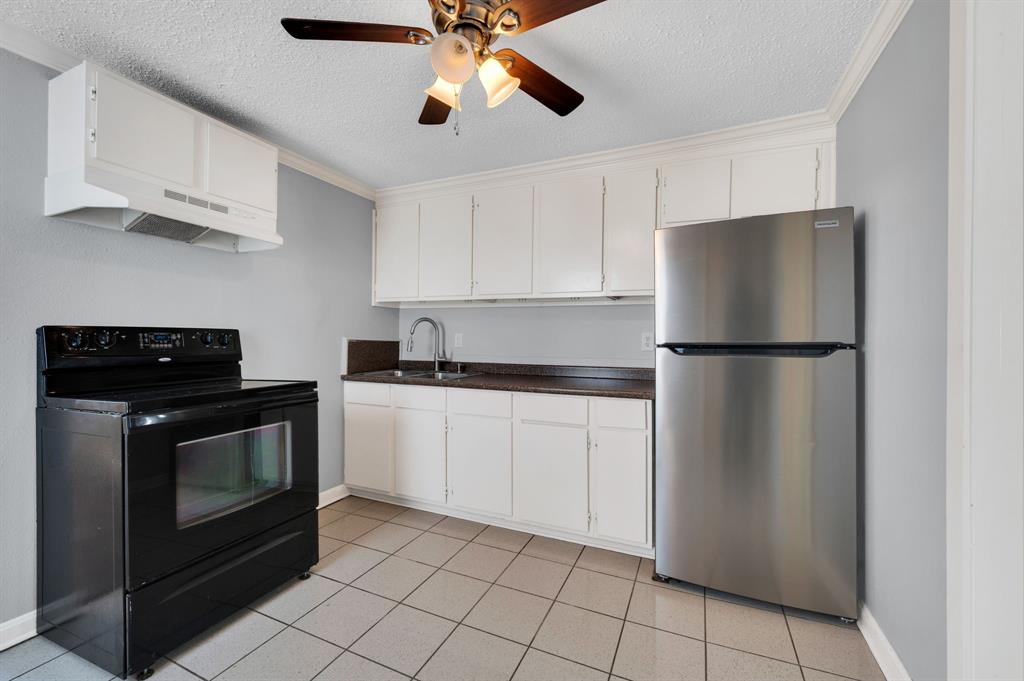 412 East Avenue F Midlothian, TX 76065 - Photo 10 of 12 a kitchen with cabinets stainless steel appliances and a counter space