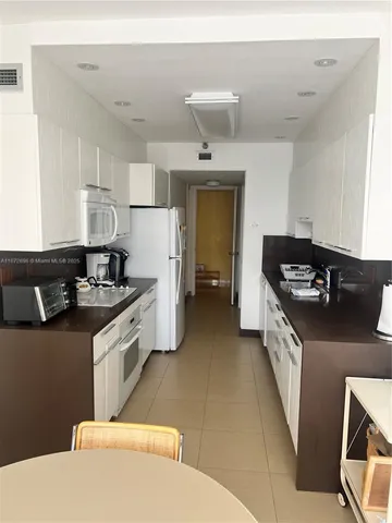 a kitchen that has a sink and a stove