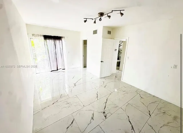 a view of a bathroom with a shower and closet