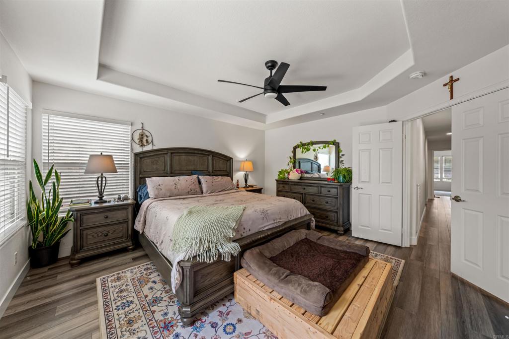 2007 Pleasant Waters Court Spring Valley, CA 91977 - Photo 13 of 22 a bedroom with a bed a mirror and a flat screen tv