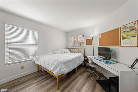 a bedroom with a bed and a desk