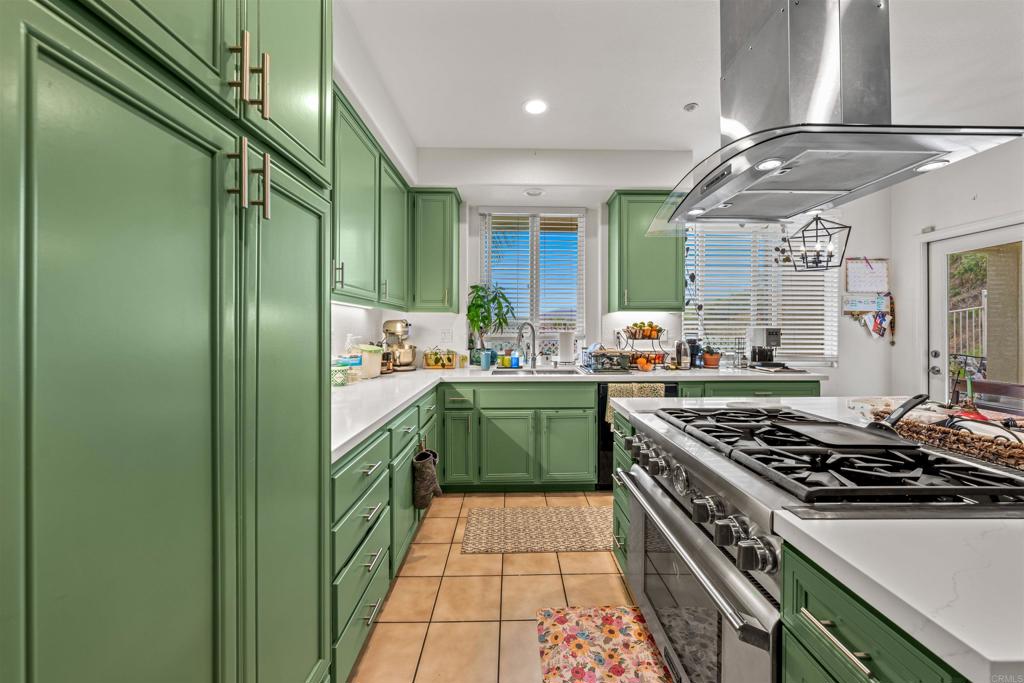 2007 Pleasant Waters Court Spring Valley, CA 91977 - Photo 4 of 22 a kitchen with stainless steel appliances a stove a sink and a refrigerator