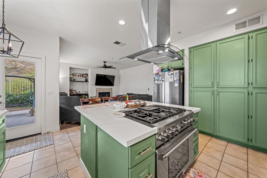 2007 Pleasant Waters Court Spring Valley, CA 91977 - Photo 6 of 22 a kitchen with stainless steel appliances granite countertop a refrigerator a sink dishwasher a stove and a refrigerator with wooden floor