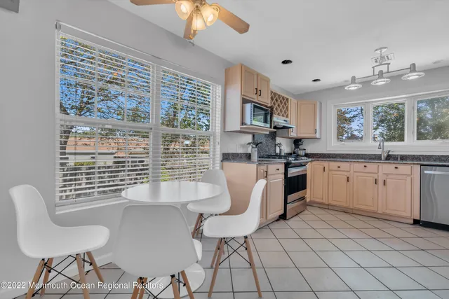 a kitchen with a sink cabinets and window