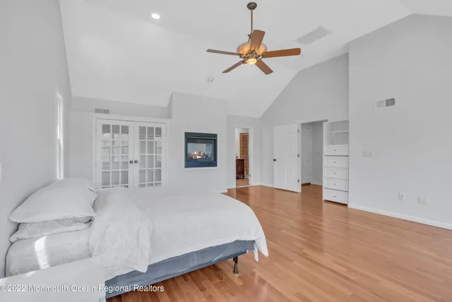 a spacious bedroom with a bed and a chandelier