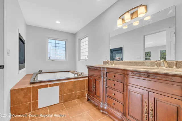 a spacious bathroom with a double vanity sink and a mirror