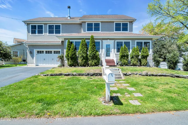 a view of a house with a yard patio and small yard