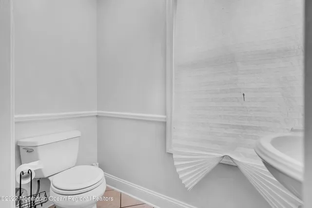 a white toilet sitting next to a bath tub