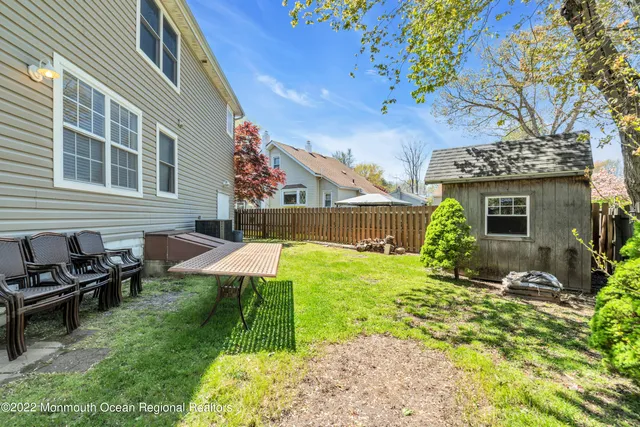 a view of backyard with table and chairs and potted plants