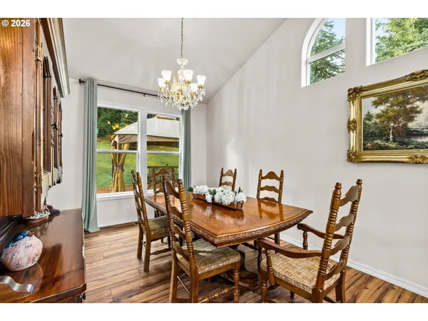 a view of a dining room with furniture wooden floor and a chandelier