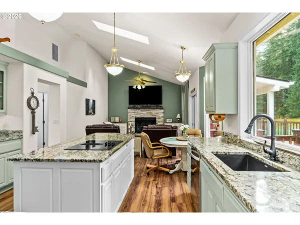 a open kitchen with stainless steel appliances granite countertop a sink stove and refrigerator