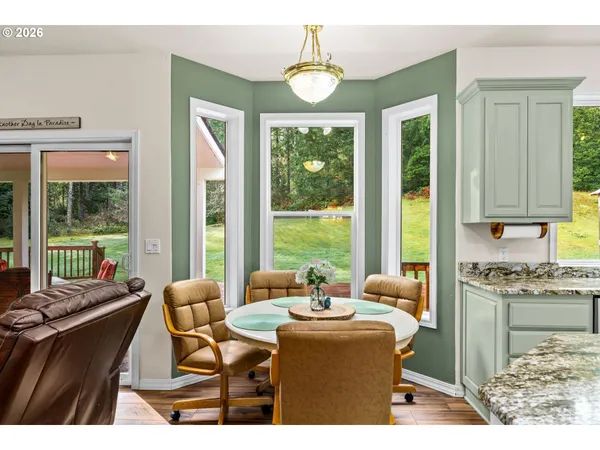 a dining room with furniture and large windows