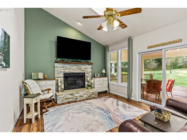 a living room with furniture a flat screen tv and a fireplace