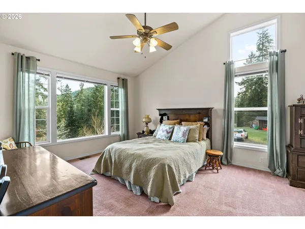 a bedroom with a bed and a large window