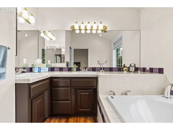 a bathroom with a sink vanity and a mirror