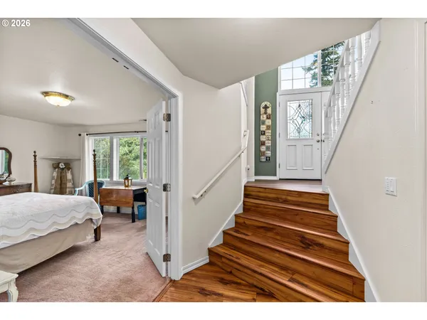a bedroom with furniture and large windows