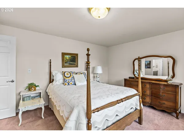 a bedroom with a bed and a dresser