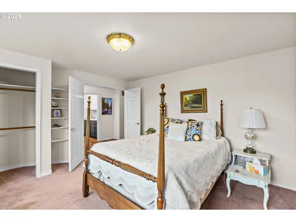 a bedroom with a bed and a view of kitchen