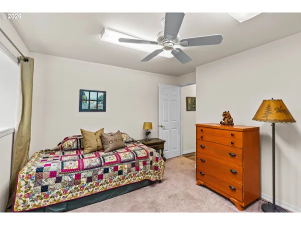 a bedroom with furniture and a ceiling fan