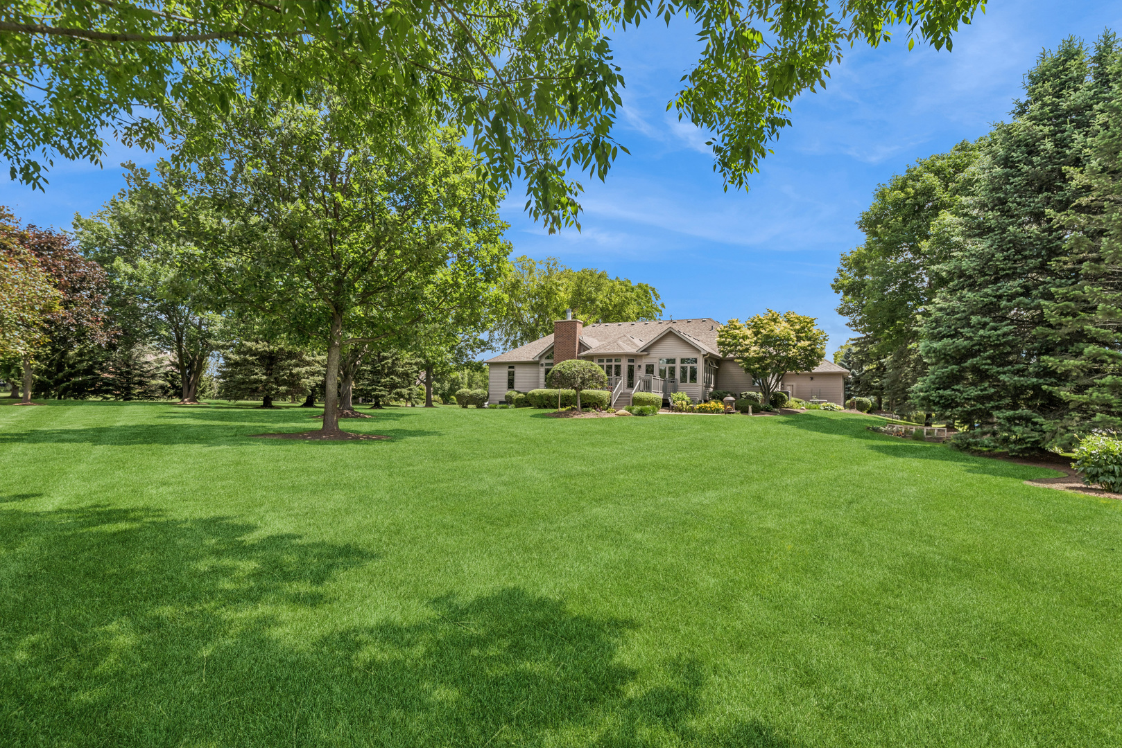 10907 Red Hawk Lane Spring Grove, IL 60071 - Photo 33 of 44 a view of house with garden space and trees