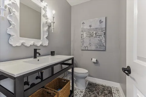 a bathroom with a sink a toilet and mirror