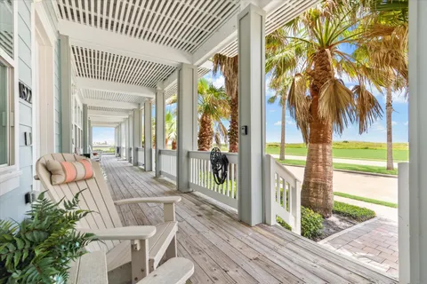 a view of a balcony with floor to ceiling windows and wooden floor