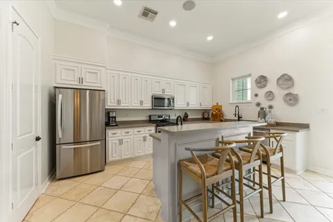 a kitchen with stainless steel appliances granite countertop a refrigerator and a stove top oven