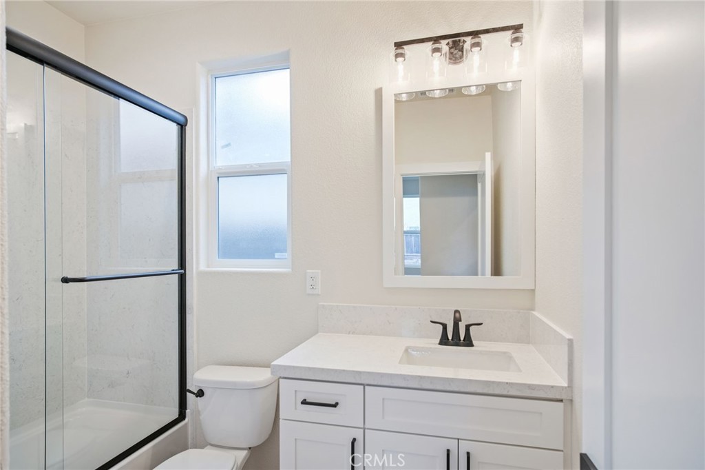 243 West 3rd Street Tracy, CA 95376 - Photo 23 of 29 a bathroom with a sink toilet and shower