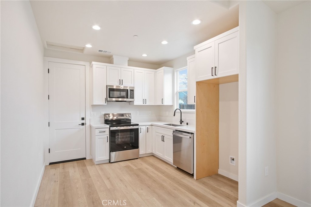 243 West 3rd Street Tracy, CA 95376 - Photo 27 of 29 a kitchen with stainless steel appliances granite countertop a refrigerator and a stove top oven