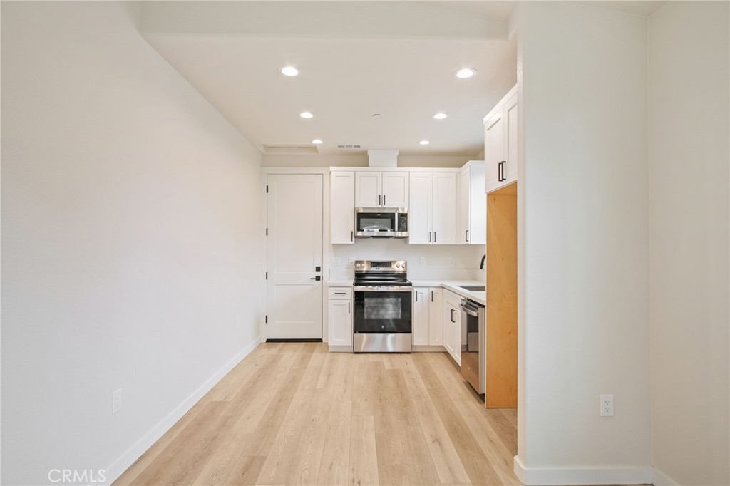 243 West 3rd Street Tracy, CA 95376 - Photo 28 of 29 a large kitchen with stainless steel appliances granite countertop a stove and a refrigerator