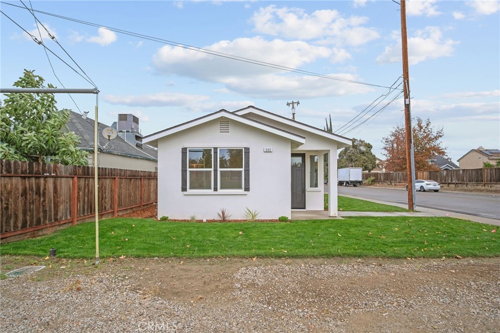 243 West 3rd Street Tracy, CA 95376 - Photo 5 of 29 a front view of a house with a yard and potted plants
