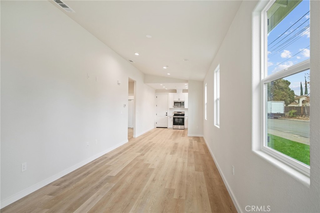 243 West 3rd Street Tracy, CA 95376 - Photo 7 of 29 a view of empty room with wooden floor and fan