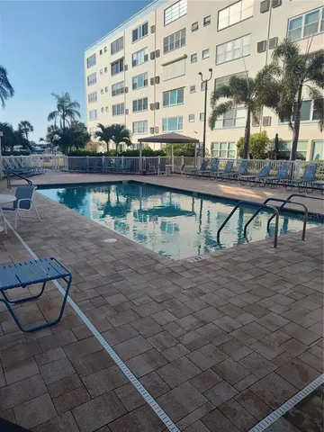 a view of a patio with dining table and chairs