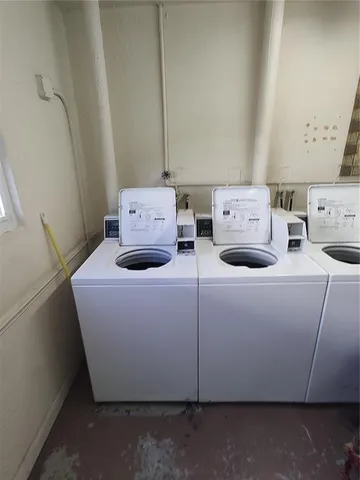 a view of a swimming pool with a yard and plants