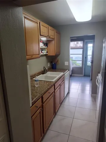 a kitchen with cabinets and appliances